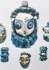 Pendenti di collana in pasta vitrea a testa barbuta rinvenuti a Olbia in Sardegna. IV-III secolo a.C. (Cagliari, Museo archeologico nazionale)