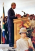 Il nuovo presidente del Sudafrica Nelson Mandela tiene il suo discorso inaugurale a Pretoria dopo la vittoria elettorale del 1994. Sotto il palco, la moglie dello sfidante De Clerk lo ascolta.